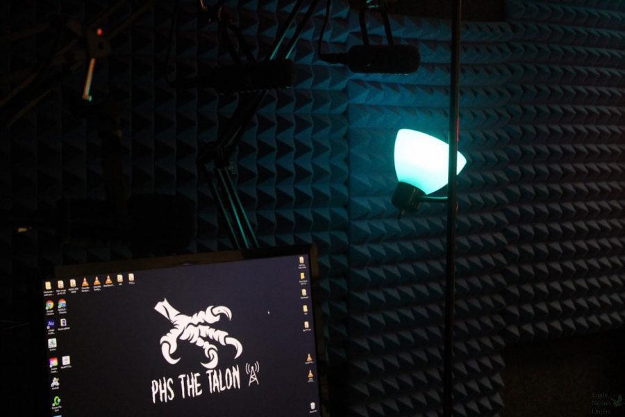 Shining blue, a light rests in the sound booth next to a computer. This year, The Talon radio is recording a second edition of The Talons Terrifying Tales. The radio posted one to two stories recorded by students per day.