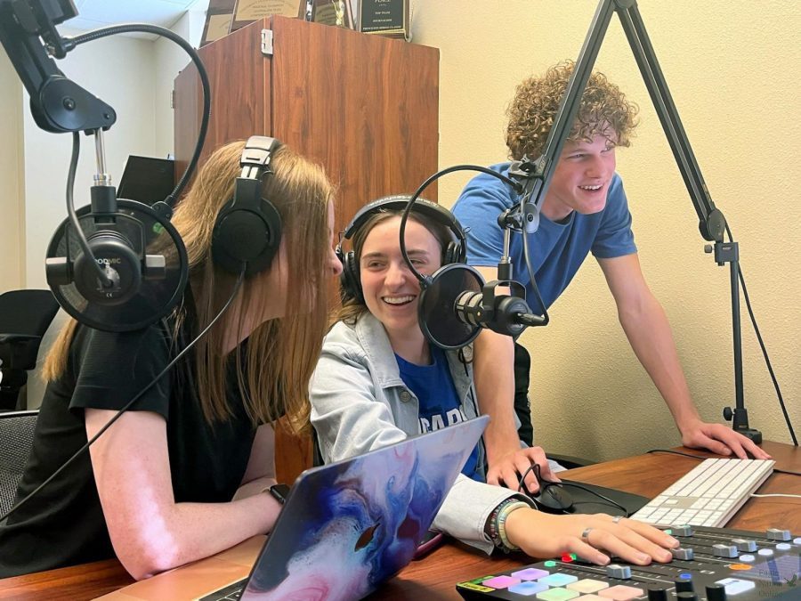 At the podcast table, seniors Caleb Audia, Christi Norris and Amanda Hare prepare for their podcast. In episode four of the second season of 