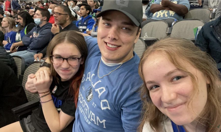 Sitting at a Dallas Mavericks basketball game over Thanksgiving break, freshman Bailey Clark, Alex Clark and senior Alyssa Clark watch the game. Alyssa Clark values her family and friends, and looks to them as motivation to grow.