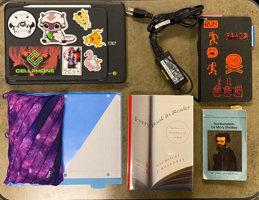 Technology and books lay on the desk. This compilation represents  everything senior Michael Ramirez uses during school. It helps to know where everything is, Ramirez said. This also keeps my backpack weight down since I always have my backpack with me at all times.