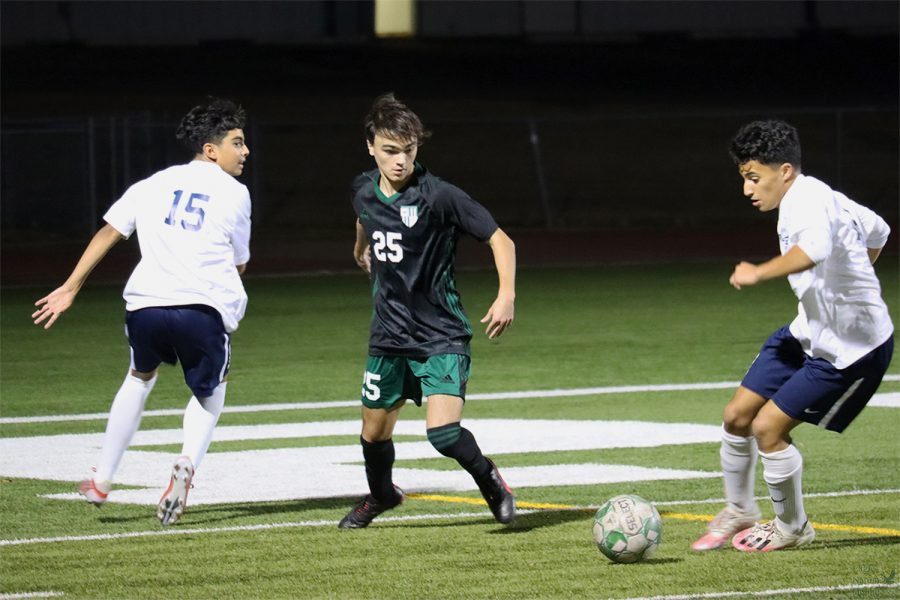 Keeping an eye on the ball, senior Aiden Mieger steps toward it. The Eagles played their second scrimmage against Lone Star at Reynolds Eagle stadium Friday, Dec. 17. The boys lost 1-0. 