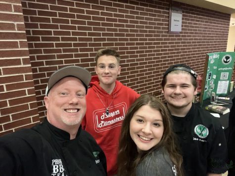 At the student expo, teacher Brett Claypoole takes a selfie with seniors Sydney Fisher, Jakob Roberts and Andrew Spain. The students participate in the culinary and barbecue programs, and Fisher is the captain of the barbecue. team. The student expo occured Wednesday, Jan. 19, from 6-8 p.m.