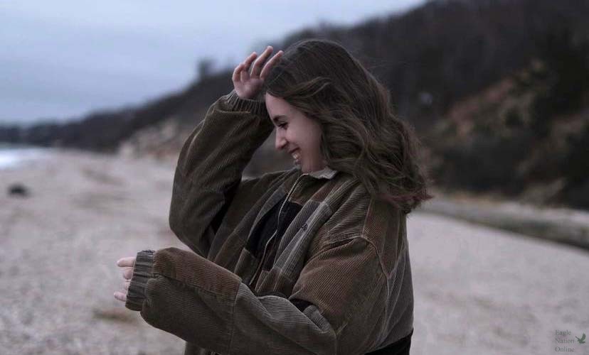 In a photo taken by Anila Ademi, junior Gianna Galante blocks her face from the wind on the beach in New York. Galante said she loves traveling and exploring new places. New York has a special place in her heart. In the attached column, Galante encourages students to find ways to take care of their mental health.