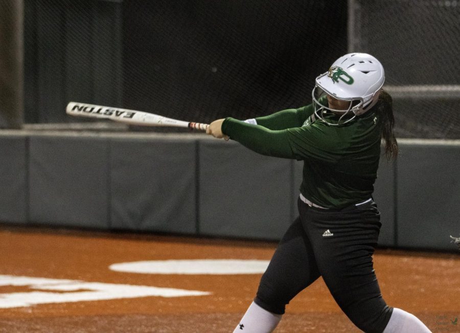 Up to bat, senior Sydney Lewis swings. Lewis is committed to the University of Maryland to continue her softball career. Lewis also plays on a club team, Texas Glory.