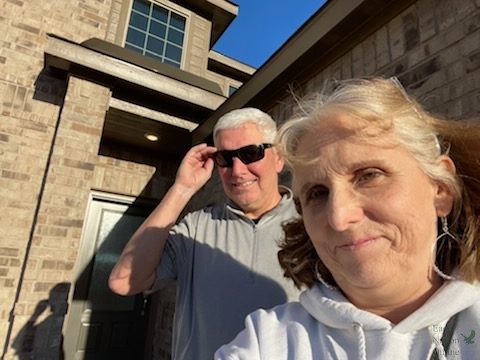 In front of their new house, teachers Lisa and Larry Roskens take a selfie. Theyve taught at the school for four years.