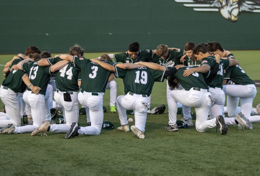 Following their pregame ritual, the team kneels and prays. The varsity baseball team played their game against Little Elm Wednesday, March 17. They won with a score of 4-0.