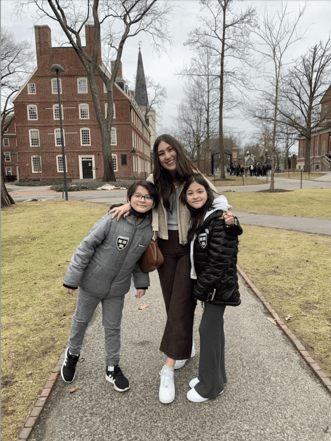 Beside her siblings, sophomore Kaya Miller stands on the Harvard University campus after a tour. After only allowing virtual tours due to COVID-19, Harvard opened up their campus for tours March 7. Miller also visited the campuses of Yale and Brown during her trip. 
