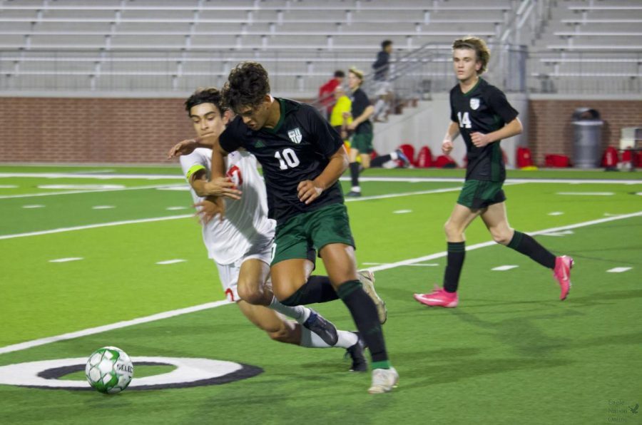 Resisting the opponent, No. 10 senior Gavyn Rosales keeps an eye on the ball. The boys won the last home game of the season against Allen. They have one more district game before playoffs.