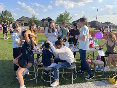 At their booth, the National Art Honor Society paints Relay for Life participants faces. Relay for Life was held Friday, April 22. The event raised money for cancer patients.