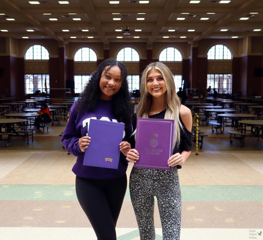 In front of the cafeteria, seniors Sydney Thomas and Grace Hale showcase their booklets. Both earned full ride scholarships to Texas Christian University and plan to be roommates. I will be studying Strategic Communications with a minor in Political Science, Hale said. I want to help out with non-profit organizations and building a bridge between them and the government.