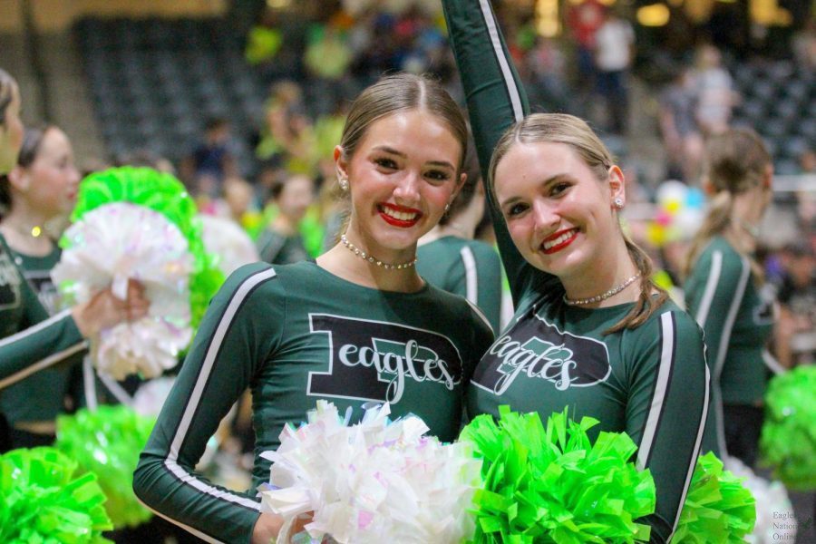 With poms in hand, seniors Madison Elledge and Abby Taylor smile for the camera. Elledge and Taylor have been on Talonettes since their freshman year. Alongside Talonettes, they participated in middle school drill team.