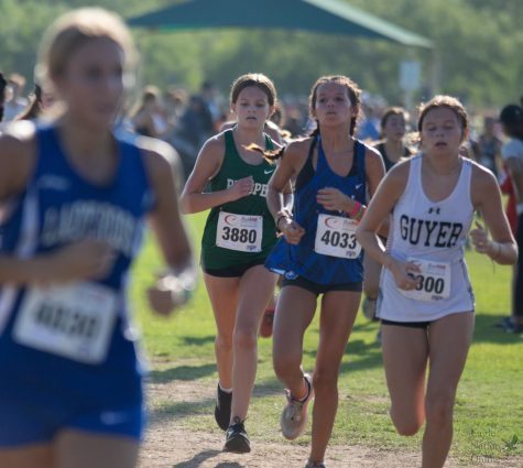 Junior varsity girls member and freshman Evelyn Ohlmeyer runs during the cross country meet Aug. 27. Varsity cross country teams competed at the Southlake Carroll Cross Country meet against 93 other teams. The attached article includes all sports events held each week.