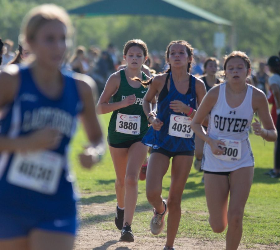 Junior varsity girls member and freshman Evelyn Ohlmeyer runs during the cross country meet Aug. 27. Varsity cross country teams competed at the Southlake Carroll Cross Country meet against 93 other teams. The attached article includes all sports events held each week.