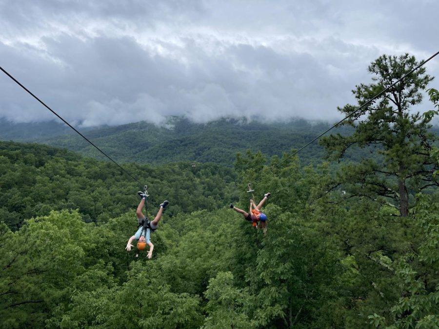 Above the Great Smoky Mountains National Park, sophomore Jake Radcliffe and sixth grader Julia Radcliffe zip over a verdant pine-oak forest. They visited the CLIMB Works Zipline Course in Gatlinburg, Tennessee, to do something they had never done before. At first, I was pretty afraid of zip lining that high up, Jake said. But when we actually started going, I had lots of fun — especially when we went upside-down.