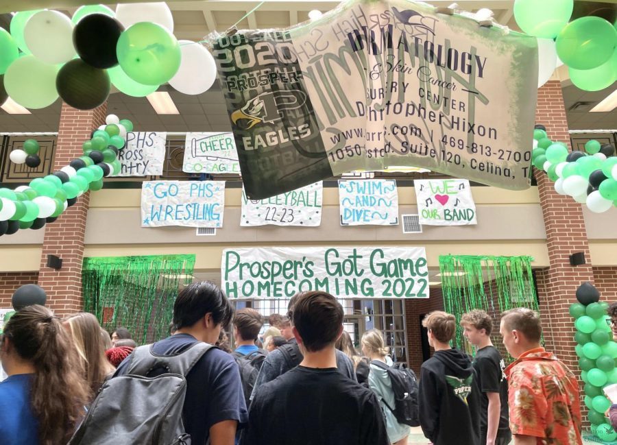 Students walk through the cafeteria entrance of Prosper High School. Balloons and other decorations hang from the walls and ceiling to celebrate Homecoming Week. The Homecoming parade took place Wednesday, Sept. 28, and the game took place Friday, Sept. 30.