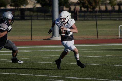 With ball in hand, sophomore Jaxon Lucas focuses on his next play of the game. Their opponent was Denton Guyer. The football team is led by Brandon Schmidt. 