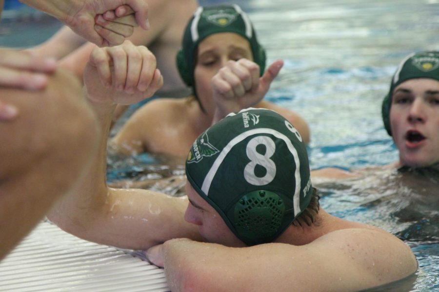While on time-out, senior Cheyne Miller fist bumps his teammate. The boys water polo team won against Denton Braswell 33-6. Im glad we won, senior Rocky Streiner said. We played a great game. 