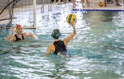 As the John Paul ll girls varsity goalie prepares for a block, Co-Captain Harper Collins attempts to win a point for her team. Prosper played their first game of the season Aug. 16, against John Paul ll in the Prosper High Schools natatorium. Prosper won 17-0. Photo courtesy of Harper Collins.