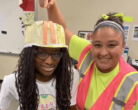 Decked out to follow the construction theme of Hope Week day two, teacher Renna Bersosa admires the dedication of her student, Veronica Fatiregun, who made her own construction hat from paper. The best most precious construction worker on campus today, Bersosa said in a tweet. No excuses for lack of school spirit, she made her own hard hat #suicidepreventionweek. 