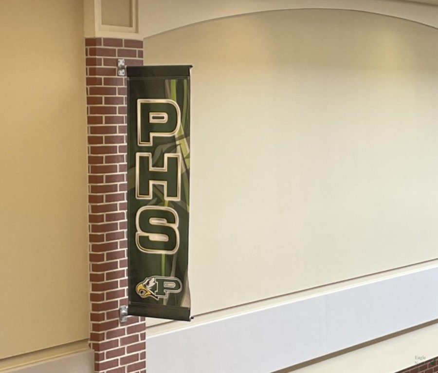 In the hallway of Prosper High School, a banner with the school colors and initials blows in the air above students as they walk to class. As the year progresses into the second 9 weeks, PHS students attend different events at the school, such as Open House night and the club fair. Senior quotes are due Oct. 28, and CADY took senior portraits at PHS Friday, Oct. 14.