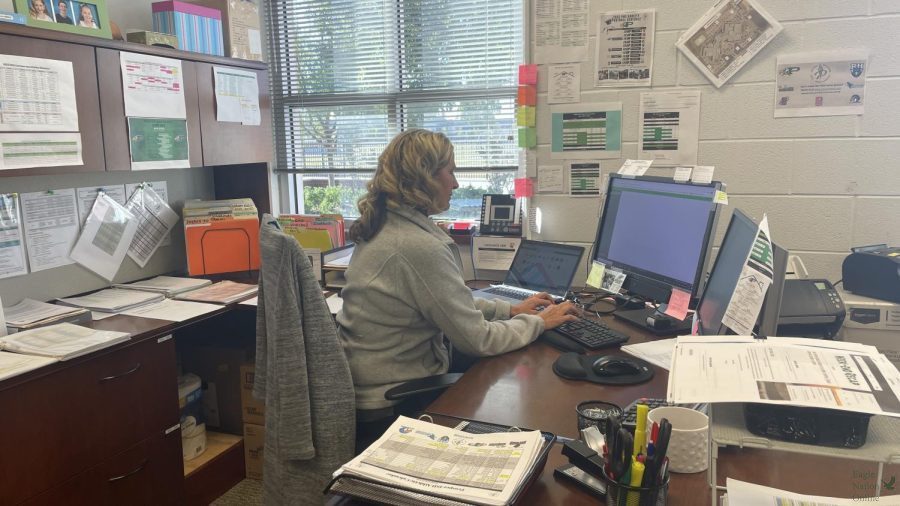 Focused+on+her+monitor+screen%2C+Paula+Adams+manages+athletic+department+tasks.+Adams+has+worked+for+Prosper+High+School+for+three+years.+She+previously+worked+at+Rogers+Middle+School%2C+which+feeds+into+both+high+schools+this+year.+Shes+always+willing+to+volunteer+to+help+out+with+anything+and+everything%2C+coach+Brandon+Schmidt+said.+She+has+been+such+an+asset+to+our+athletic+department+here+at+Prosper+High+School.