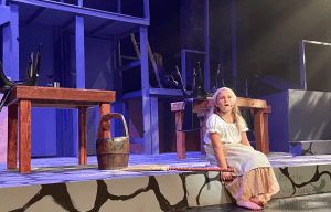 Sitting at the foot of the stage, Summer Haslam sings Castle on a Cloud as her character in the show young Cosette. Les Misérables will open from Nov. 3-5. The show will take place in the PHS Auditorium.