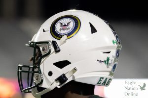 With the US Navy sticker showcased on his helmet, sophomore Jayden Beasley turns his head to watch his teammates warm up. All branches of the military were showcased on players helmets in honor of Veterans Day. The Eagles won 28-3.