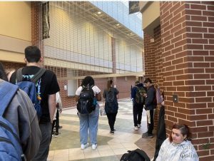 At 8:32 a.m., students wait for the gates to go up at 8:35 a.m. to allow them to get to first period. The gates stay down before 8:35 a.m. to prevent students from roaming the school unless they have tutoring or club meetings. The gate policy is new this year. 