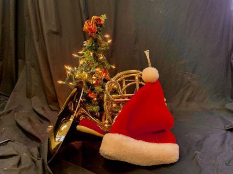 Sitting next to a small Christmas tree and santa hat, freshman Ximena Castro’s french horn reflects the tree’s lights. The Prosper Band will have their holiday concert Dec. 12 at 6:30 p.m. in the auditorium. Multiple bands will be performing in the concert.