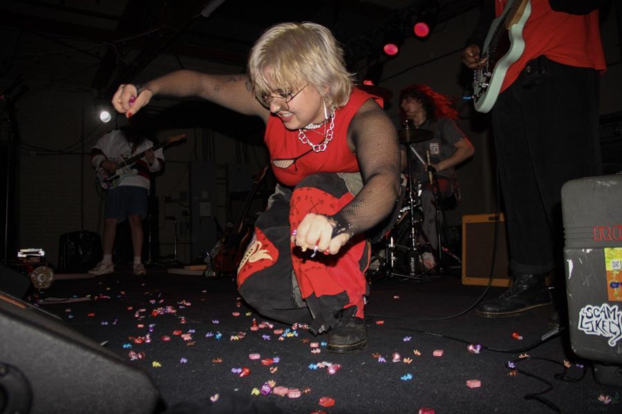 In front of a sold out crowd of fans, lead singer Charlee Grider of Milwaukee punk band Scam Likely throws candy to the audience.  The band played at The Back Room at Colectivo in Milwaukee, WI for their first studio album release show. The album “Getting Worse” was released Jan. 20 and is out of all platforms.