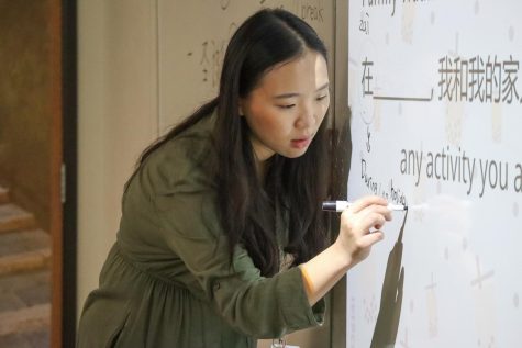 Writing on the board, Kao shows her students Chinese characters. I enjoy the classroom environment, freshman Michelle Kumanova said. I feel like its very inviting, and nice and cozy.