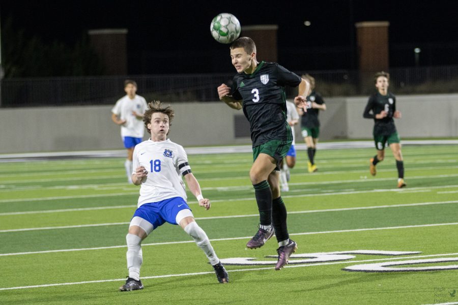 Extended in the air, sophomore Carson Stiglets heads the ball toward his teammate. This is Stiglets second year on varsity. He was named 6A District 5-6A First Team All District for the 2022 UIL season.