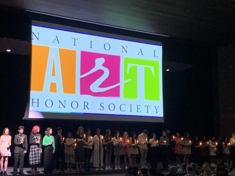 Inductees to the National Art Honor Society stand with lit candles on the stage of the auditorium at Rock Hill High School. The Induction ceremony took place at 6:30 p.m. on Jan. 25. Each new member was named as they walked onto the stage.
