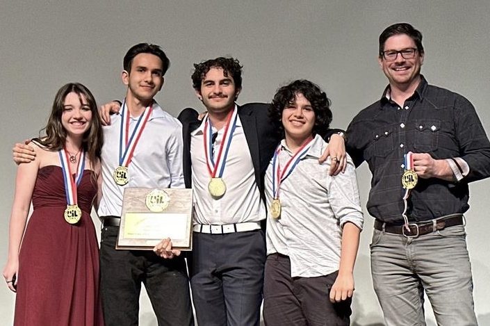 Wearing+their+first+place+medals%2C+seniors+Eliana+Hamilton%2C+Giovanni+Spampinato%2C+Micheal+Soler%2C+freshman+Rocco+Spampinato+and+adviser+Micheal+Logan+stand+as+they+are+honored+for+their+animated+films+placement.+Their+film+Lift+competed+in+the+UIL+Academic+Young+Filmmakers+Championship+and+received+first+place+in+the+6A+Traditional+Animation+category.+I+fully+anticipate+that+this+animation+will+be+recognized+at+high+school+film+festivals+across+the+nation+and+maybe+the+world%2C+Logan+said.+I+am+extremely+proud+of+all+of+the+hard+work+by+this+%28senior+student%29+trio+in+my+class%2C+along+with+Rocco%2C+and+I+couldnt+be+happier.