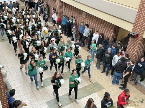 Pictured above is the send-off that took place Feb. 16 at 8:50. The send-off celebrated the advancement to state competitions by DECA, Eagle Production Group, wrestling and swim and dive. After attendance, students were told to line the upper and lower main halls to cheer for the teams as they walked from the auditorium to the arena.