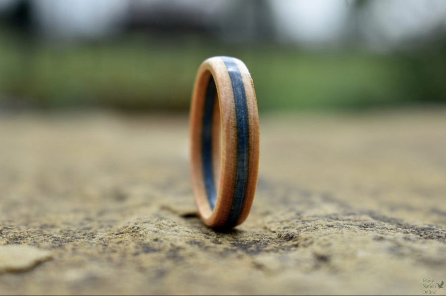 Outside, a new color option of skateboard ring, made by junior Reaves Lo, sits on the ground. Lo takes his own product photography for his Etsy shop. Lo offers a variety of colors and widths of rings in his shop. 
