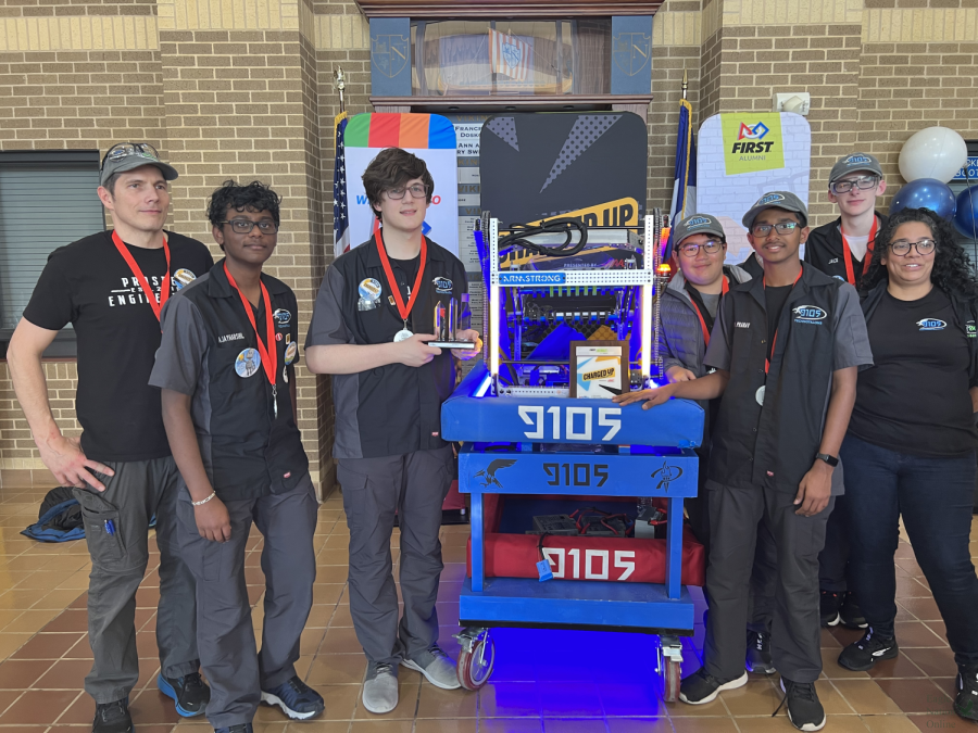 Standing+next+to+their+robot%2C+team+9105+TechnoTalons+honor+their+second+place+win.+The+team+consists+of+adult+mentor+Leonard+Milholland%2C+sophomores+Ajay+Sivachandar%2C+Aaron+Milholland%2C+Jack+Demeterio%2C+freshman+Pranav+Chiqakkagari%2C+junior+Jack+Cooksey%2C+and+adult+mentor+Liz+Phillips.+The+team+also+works+with+district+elementary+schools+as+well+as+the+Special+Olympics+teams.