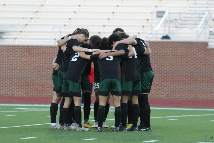 Standing in a circle, the mens varsity soccer team prepare to start the game. This was the first game of the playoffs. The Eagles played against Flower Mound Marcus.