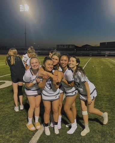 On the field, senior Quinn Hungerford (on right) stands beside teammates alumni Amandalynn Garst, and Cosette Brockbank, and seniors Charis Tomboc and Madeleine Miles. Hungerford is a varsity defensive player for the Prosper girls lacrosse team. Hungerford joined the team when she moved to Prosper her junior year. 