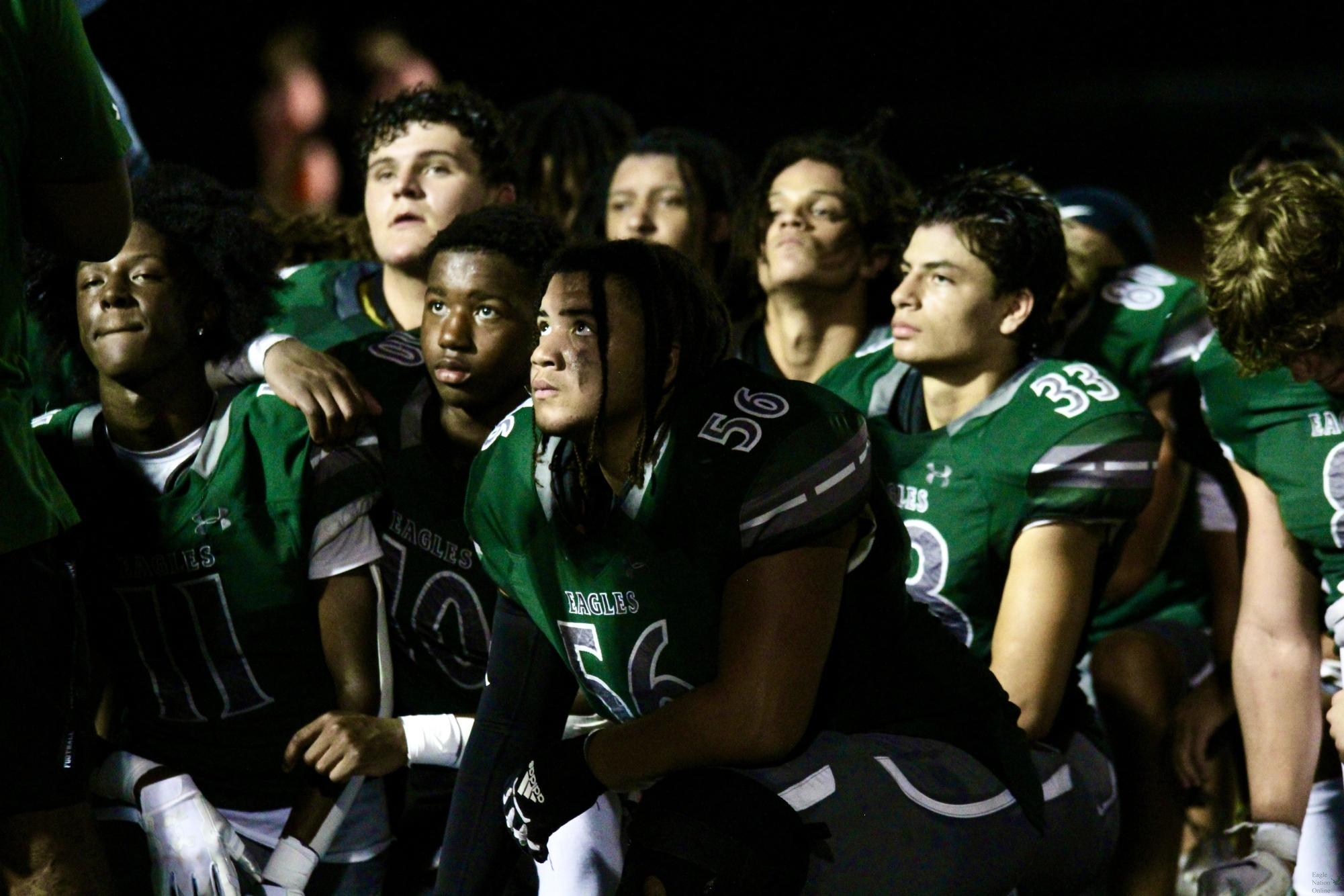 Huddled with his teammates, junior Dailen Dickerson looks up toward the coaches. Dickerson plays defensive tackle. Prosper ended the night with a victory against Rockwall.