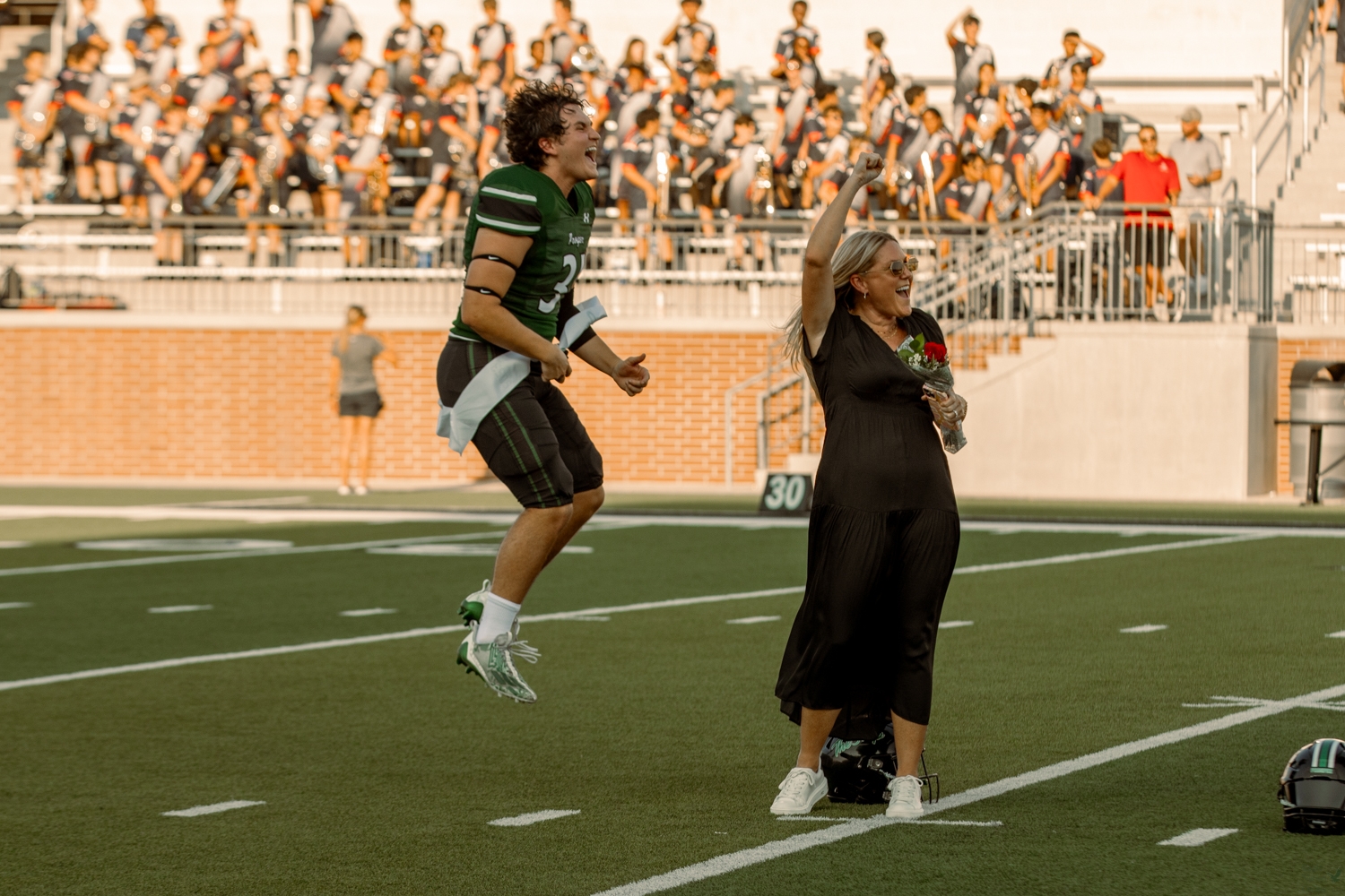 As his name is announced, senior Parker Browning celebrates winning homecoming king with his mom Jennifer Browning. Browning won king with senior queen Brianna Marler. Browning is on the varsity football team and Marler is the captain of the Talonettes drill team. More homecoming photos will publish tomorrow, too.