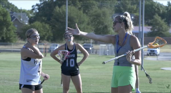 Arm extended, girls lacrosse coach Morgan Alexander talks to junior Tara Haines. This is Morgans first year coaching at Prosper. I think I found a different appreciation for the game through coaching, Alexander said. Inspiring young kids now and not being the one playing is a different vibe, but I do love it.