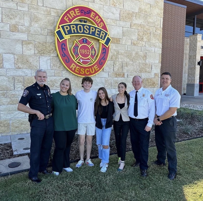 In front of the fire station sign, Prosper Police Department Chief Doug Kowalski, junior Christina Krasnova, senior Parker Reynolds, junior Isabel Multer, senior Riley McConnell, Fire Department Assistant Chief Shaw Eft and Fire Department Chief Stuart Blasingame finish off the training hosted at the Childrens Health Stadium. Reporters from ENN and ENO got to attend the training for Prosper PD, FD, FBI, PISD and others. A slideshow and story will publish on the specifics of the mock event. 