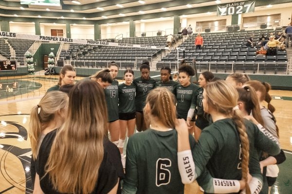 Eyes on one another, Prosper volleyball huddles before a home game. Prosper finished the regular season with a 34-9 record. They are led by coach Ashlee McCormick. The team will compete in the first round of the state championship tournament on Friday Nov. 17 at 5 p.m. at the Curtis Culwell Center in Garland. With a win, the team will advance to the championship on Saturday, Nov. 18, at 5 p.m. in the same location.