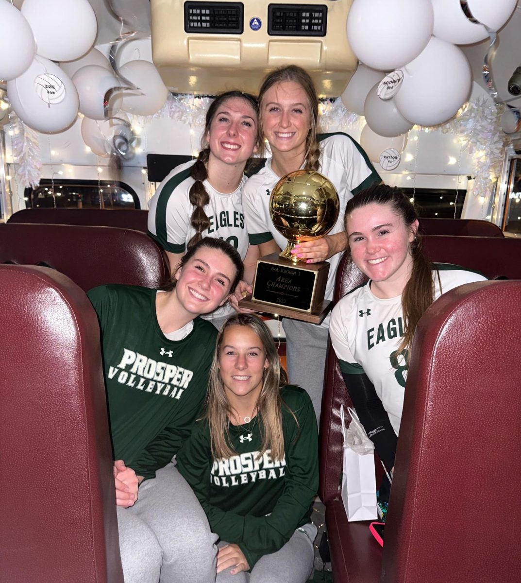 Holding a trophy, varsity volleyball seniors Allie Duits, Sydney Thornton, Ayden Ames, Taylor Gardner and Reese Renfrow celebrate winning the Area Champions title. The team will face Allen High School on Tuesday Nov. 7. Ames decommitted from Nebraska University and committed to University of Texas. 