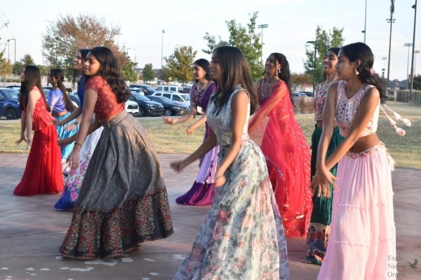 With Bollywood music playing, freshman Tanushri Vijayakumar leads members of the Bollywood Dance Club. The group performed many dance routines at the Diwali celebration, hosted Nov. 18 by the Indian Student Association at Frontier Park. Us Indians love expressing ourselves through our moves and how we do stuff, sophomore Anish Moilla, president of the Prosper Bollywood Dance Club, said. So, dance and music is one of our favorite ways to get out there and enjoy ourselves.