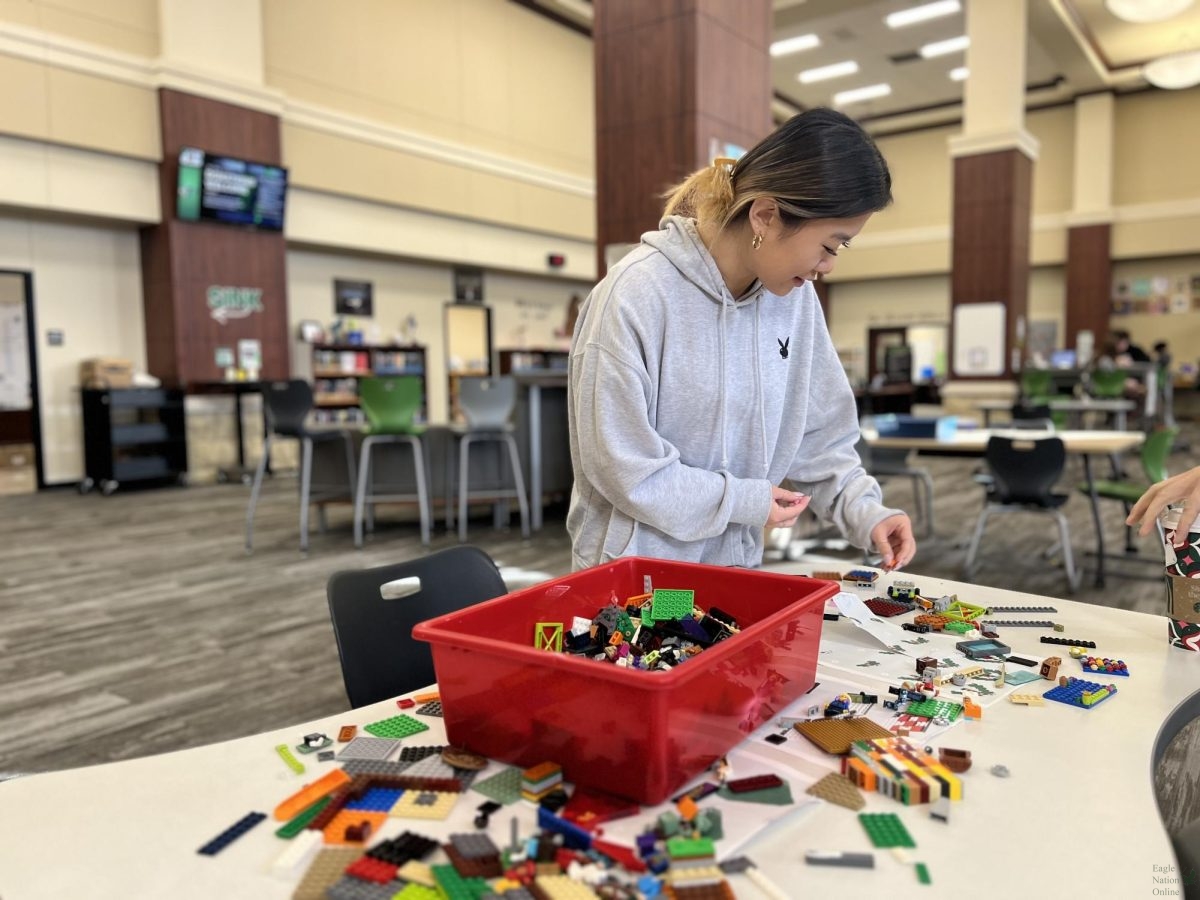 In the Nest, senior Kaylyn Chung puts together Legos. There is a competition between the PISD high schools to donate toys to children for the holidays. The school of the most amount of Lego hearts built on their Lego wall will win. 