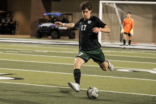 Eyes on the ball, senior Tate Jones prepares to pass the ball to his teammate. The Eagle soccer season will start Dec. 8 against Hebron High School. District matches begin in January. 