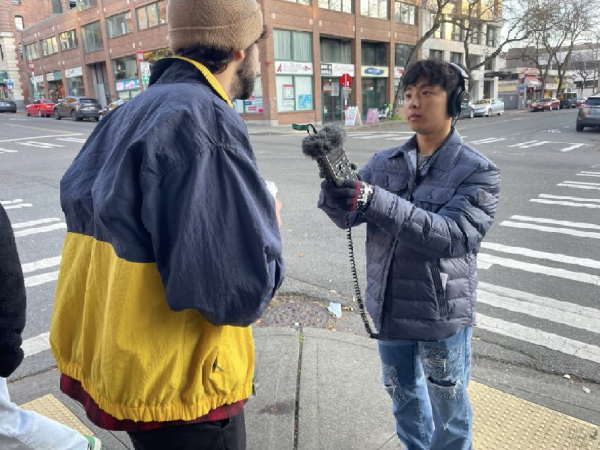 Microphone in hand, senior James Kim interviews someone on the streets of Seattle. On Our Minds, like many other podcasts, allows Kim the opportunity to interview outside voices. Kim met with the podcast On Our Minds team in Seattle, and began production. I never realized that it could be such a creative outlet for me, Kim said. I remember growing up I was really into theater or  choir and going into high school I started letting go of that. And so its cool to revive that part of me, and just have that creative side of me always functioning throughout the week.