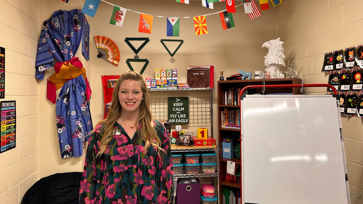 Surrounded+by+flags%2C+and+decorations%2C+ESL+teacher+Karla+Reyes+prepares+to+receive+a+student+in+her+classroom.+The+ESL+program+supports+students+who+are+learning+the+English+language.+Theyre+all+at+all+different+levels%2C+and+some+kids+are+newcomers%2C+Reyes+said.+So%2C+they+just+moved+here%2C+and+they+have+no+English+background+from+their+home+country.+Then%2C+we+have+some+students+who+learned+English+in+their+home+country%2C+or+theyve+been+somewhere+else+in+the+United+States+and+just+are+still+working+on+developing+their+fluency.